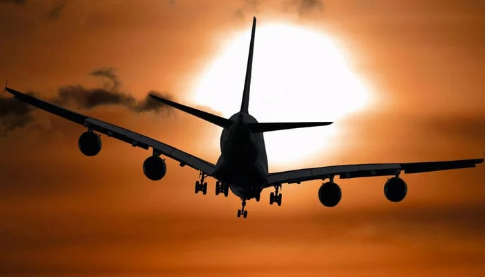 This representational image shows a silhouette of an aircraft in flight. — Pexels